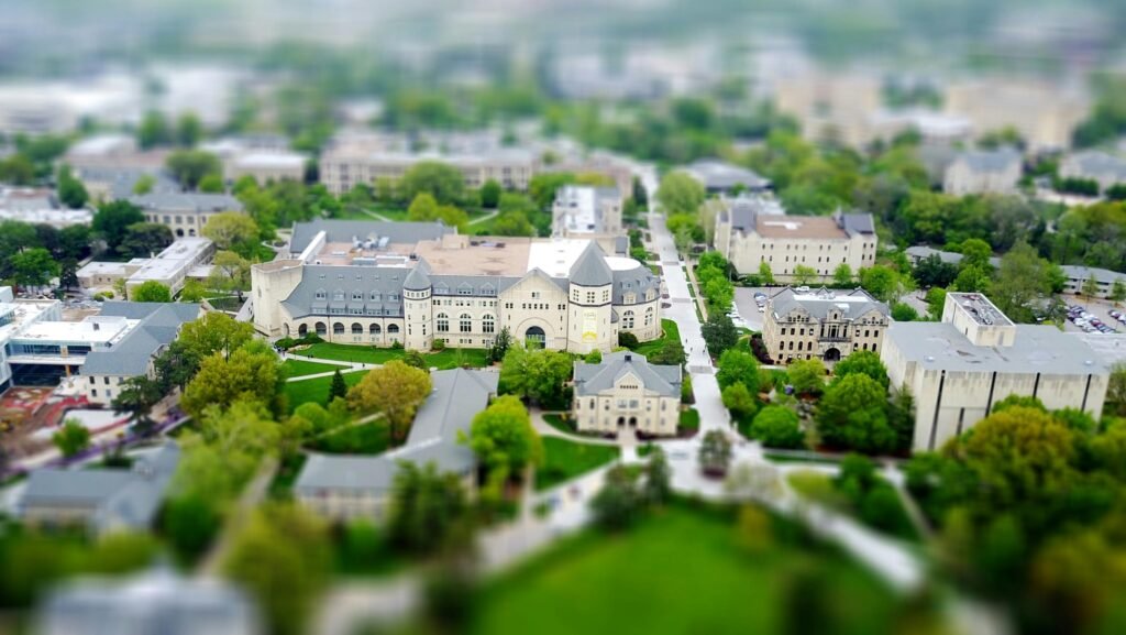 Aerial view of the Kansas State University campus in Manhattan, KS with green spaces and historic buildings.